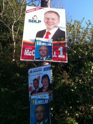 Sinn Fein posters mounted on top of other party posters in East Antrim