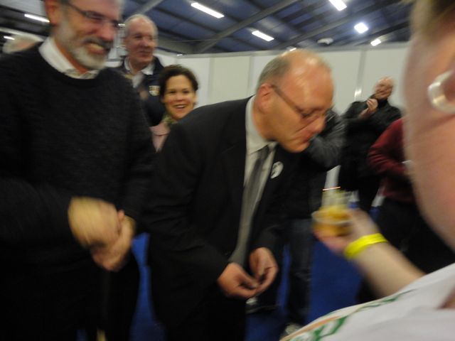 Paul Maskey blowing out candles on a muffin - it's his birthday