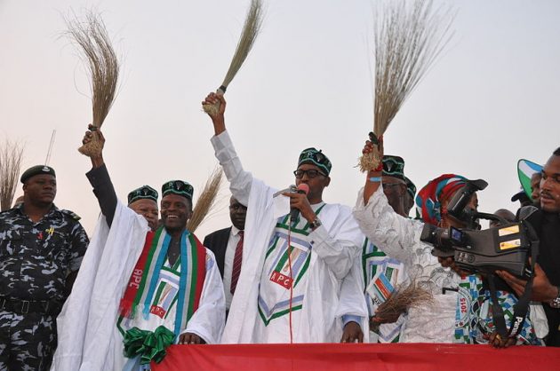 General Buhari holding a broom "to sweep Nigerian politics clean"£ at a campign rally. Photo: Heinrich Böll Foundation.