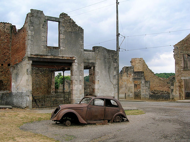 Burned out cars and buildings still litter the remains of the original village of Oradour-sur-Glane