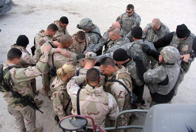 SOUTHWEST ASIA (AFPN) -- Airmen and Soldiers take a moment to pray for each other's safety before heading out for another day of convoy duty in Iraq. The Airmen run the convoys into Iraq and the Soldiers, in their armored trucks, escort them. (U.S. Air Force photo by Staff Sgt. Scott Campbell)