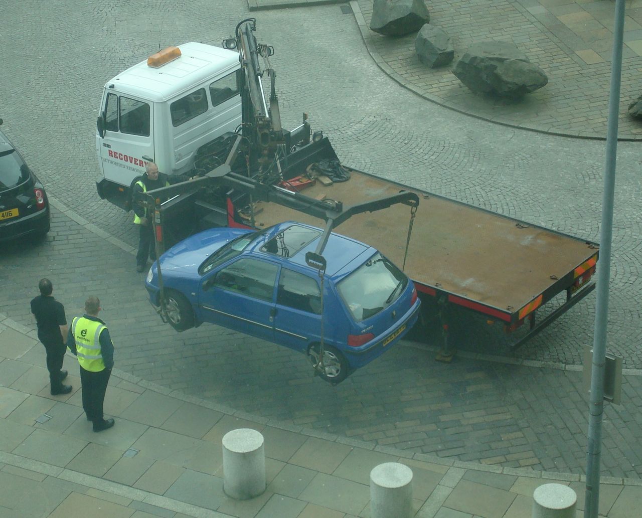 Car being lifted and towed away in front of Belfat Hilton Hotel in 2008