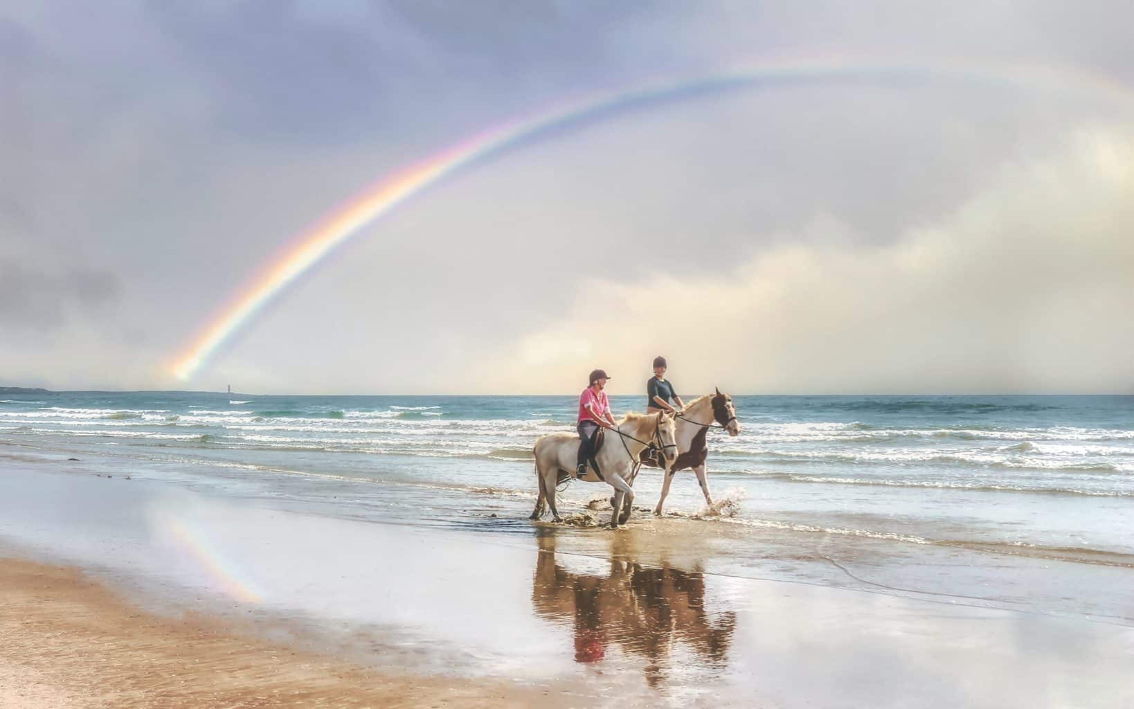 Equestrians on Tyrella Beach: riding under a rainbow (Sep., 2020).