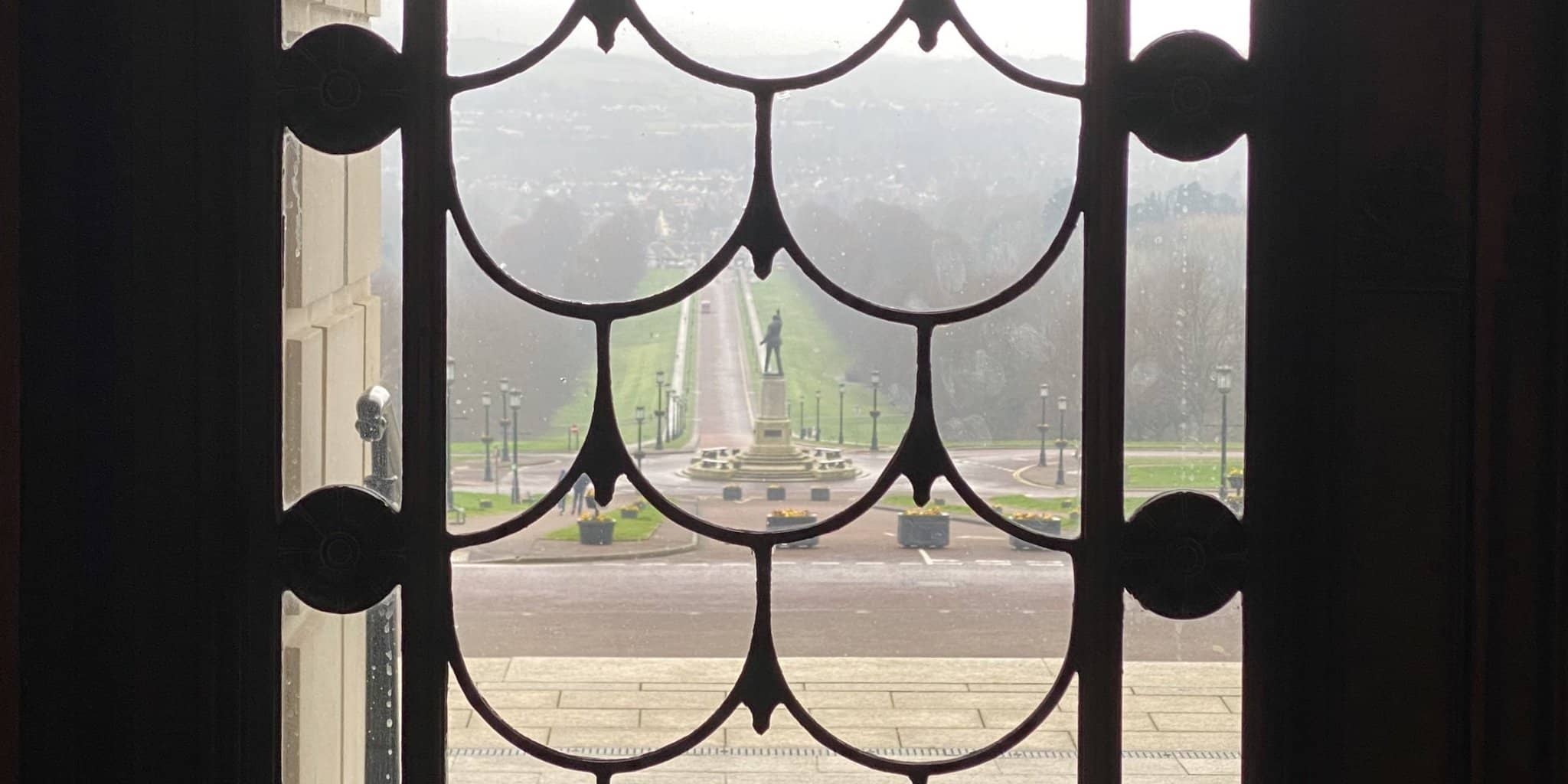 Looking through the Parliament Buildings' door at the misty east Belfast at the bottom of the hill