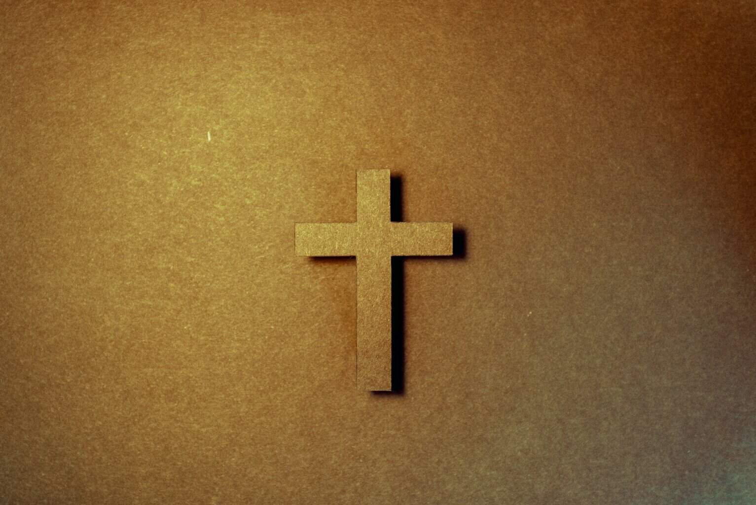 brown cross on brown surface