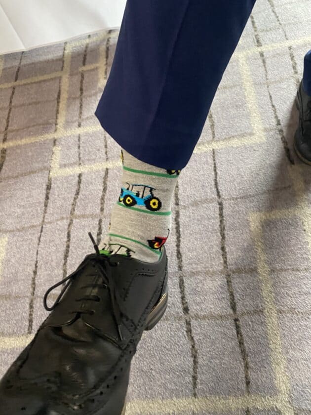 Andrew Muir shows off his tractor socks