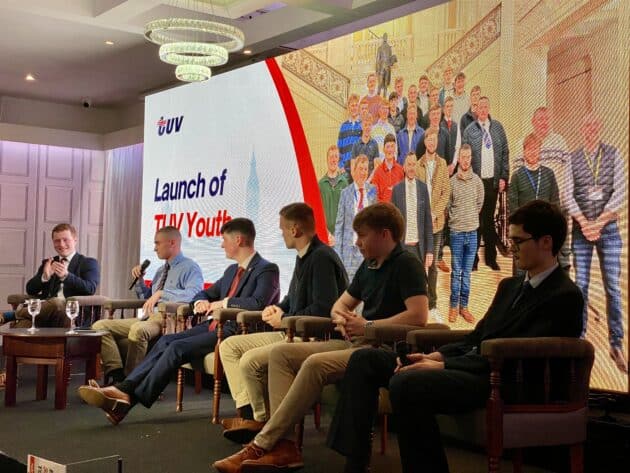 TUV Youth Voice panel at 2026 conference - six young men on stage with a photo on the video wall behind them featuring 30 young men