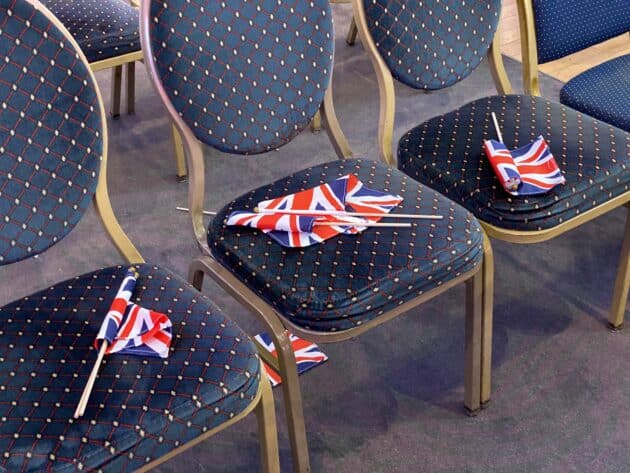 Small union jack flags sitting on top of hotel chairs
