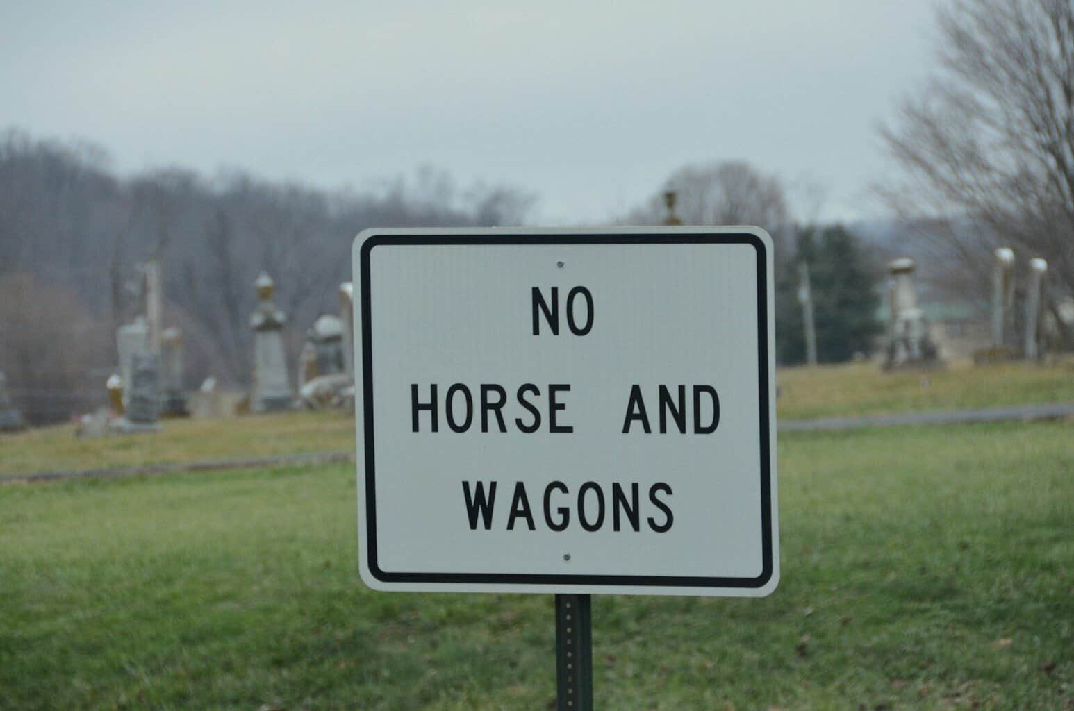 No horse and wagons sign in a cemetery