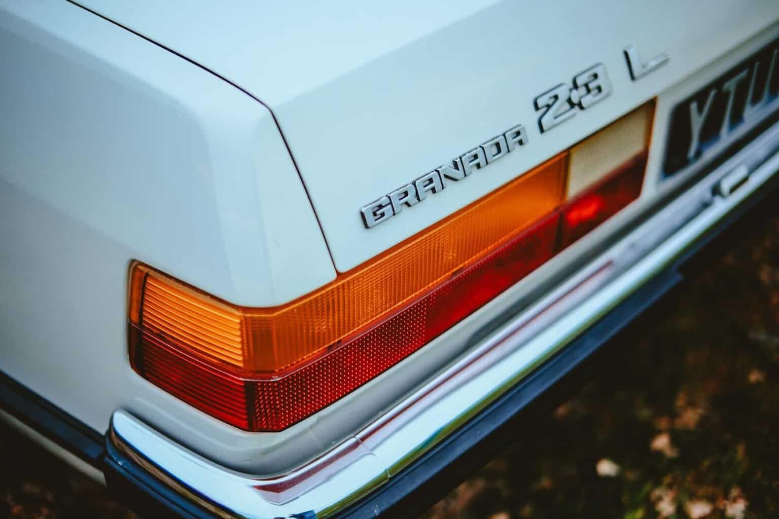 a close up of the tail lights of a white car