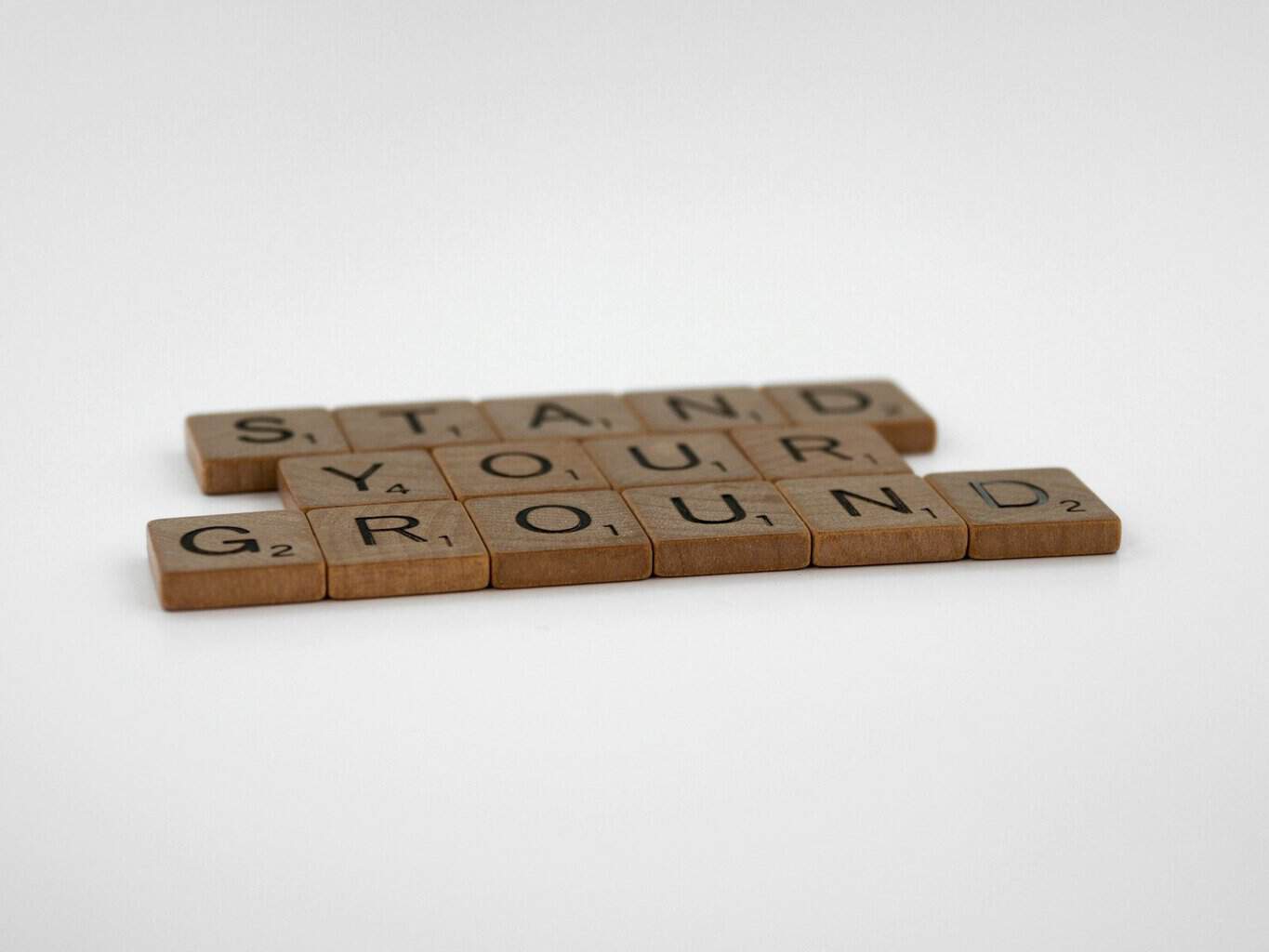 a couple of scrabble tiles sitting on top of a table